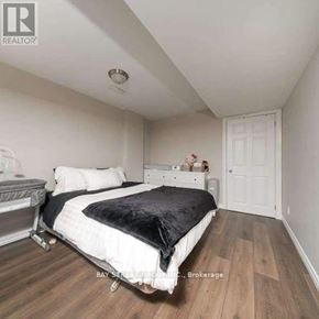 Markham (Rouge Fairways) apartment for rent - A bedroom with a bed, nightstand, and a dresser.