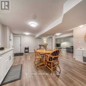 Markham (Rouge Fairways) apartment for rent - A well-lit dining area with a wooden table and chairs.