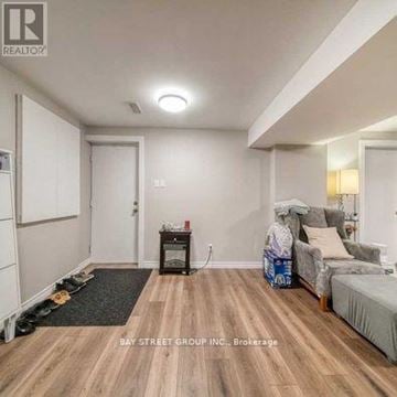 Markham (Rouge Fairways) apartment for rent - A living room with a grey sofa and a black coffee table.