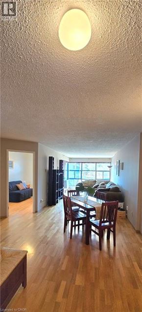 Hamilton condo for rent - A dining room with a wooden table and chairs.