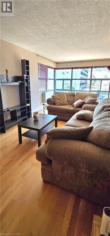 Hamilton condo for rent - A living room with a brown couch and a black coffee table.