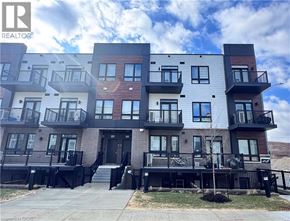 Kitchener townhouse for rent - A building with a balcony and a black railing.