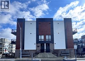 Kitchener townhouse for rent - A modern building with a white and red facade is shown in the image.
