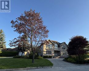 Mississauga (Rathwood) apartment for rent - A large house with a tree in front of it.