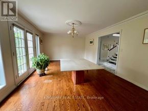 Mississauga (Rathwood) apartment for rent - A room with wooden floors and a chandelier.