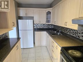 Toronto (Victoria Village) condo for rent - A kitchen with white appliances and white cabinets.