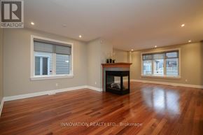 Ottawa apartment for rent - A spacious room with a fireplace and wooden flooring.