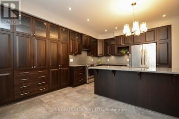 Ottawa apartment for rent - A modern kitchen with dark wood cabinets and a black countertop.