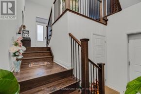 Oakville (Nw Northwest) apartment for rent - A staircase with a wooden handrail and a carpeted runner leads to a door at the top.