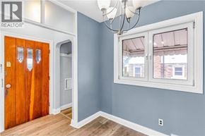 Kitchener apartment for rent - A room with a wooden door and a window with a white frame.