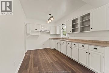 Windsor apartment for rent - A kitchen with white cabinets and a wooden floor.