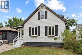 Windsor apartment for rent - A white house with black shutters and a brown roof.