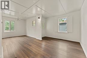 Windsor apartment for rent - A spacious room with wooden flooring and white walls.