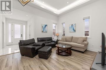 Collingwood triplex for rent - A living room with a black leather sofa set and a wooden coffee table.
