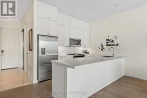 Innisfil townhouse for rent - A white kitchen with a refrigerator, microwave, and oven.