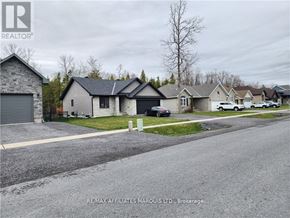 South Stormont apartment for rent - A residential street with houses and cars parked on the side.