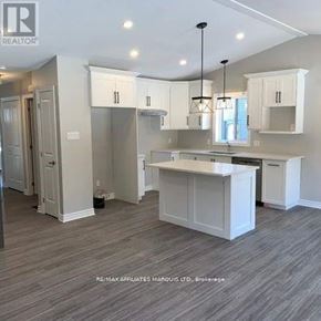 South Stormont apartment for rent - A well-lit kitchen with white cabinets and a central island.