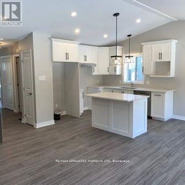 South Stormont apartment for rent - A well-lit kitchen with white cabinets and a central island.