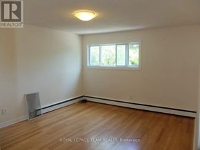 Ottawa multi-family for rent - A room with wooden flooring and a window.