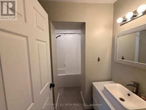 Barrie (City Centre) apartment for rent - A bathroom with a sink, mirror, and shower.