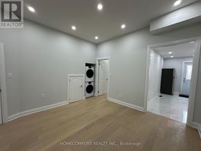 Toronto (Weston-Pellam Park) duplex for rent - A room with a white wall and a wooden floor.