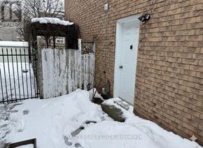 Pickering (Village East) apartment for rent - A snow-covered ground with a white door and a brick wall.
