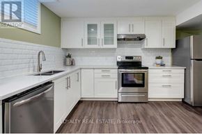 Pickering (Village East) apartment for rent - A modern kitchen with white cabinets and stainless steel appliances.