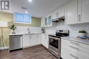 Pickering (Village East) apartment for rent - A kitchen with white cabinets and a stove top oven.