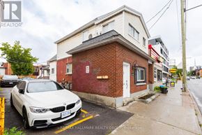 Ottawa apartment for rent - A white BMW is parked in front of a red brick building.