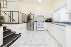 Ottawa apartment for rent - A kitchen with white cabinets and a marble floor.