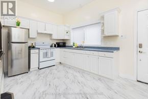 Ottawa apartment for rent - A kitchen with white cabinets and a marble floor.