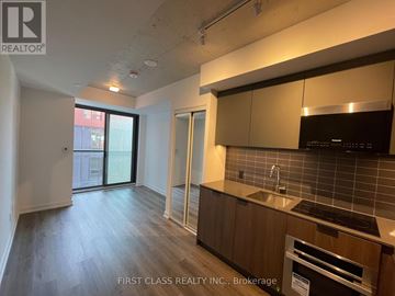 Toronto (Moss Park) condo for rent - A kitchen area with a sink and a stove top oven.