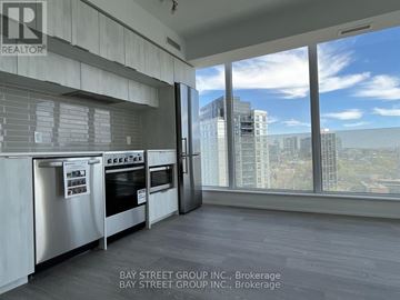 Toronto (Church-Yonge Corridor) condo for rent - A modern kitchen with a view of the cityscape outside the window.