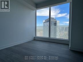 Toronto (Church-Yonge Corridor) condo for rent - A room with a large window overlooking a cityscape.