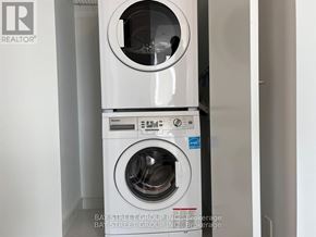Toronto (Church-Yonge Corridor) condo for rent - A white washing machine with the door open is in a room.