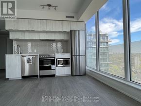 Toronto (Church-Yonge Corridor) condo for rent - A modern kitchen with a view of the cityscape outside the window.