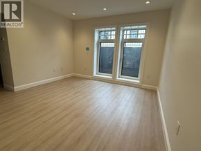 Vancouver apartment for rent - A room with a window and wooden flooring.