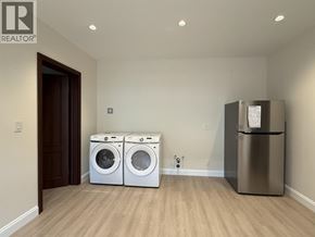 Vancouver apartment for rent - A laundry room with a washer and dryer and a refrigerator.