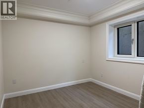 Vancouver apartment for rent - A room with a window and wooden flooring.