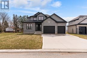 North Middlesex (Parkhill) apartment for rent - A modern house with a grey exterior and a black garage door.