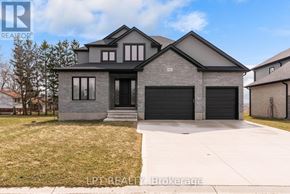 North Middlesex (Parkhill) apartment for rent - A modern house with a grey front yard and a black garage door.