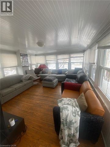 Guelph apartment for rent - A living room with a grey couch and a brown leather chair.
