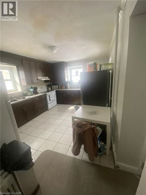 Guelph apartment for rent - A kitchen with a white fridge and a white dishwasher.