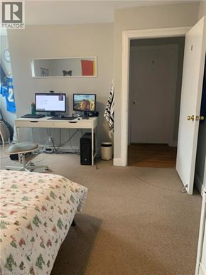 Guelph apartment for rent - A bedroom with a bed, desk, and chair.