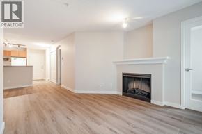 Burnaby apartment for rent - A spacious living room with a fireplace and hardwood floors.