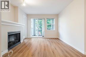 Burnaby apartment for rent - A spacious room with a fireplace and sliding glass doors leading to a balcony.