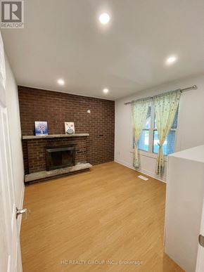 Toronto (Broadview North) apartment for rent - A room with a fireplace and a window with curtains.
