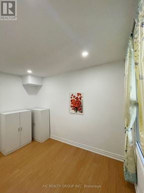 Toronto (Broadview North) apartment for rent - A room with two white cupboards and a painting on the wall.