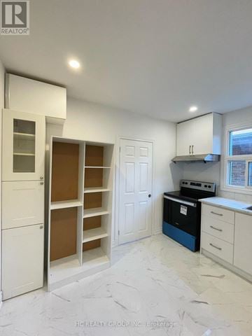 Toronto (Broadview North) apartment for rent - A kitchen with white cabinets and a blue dishwasher.
