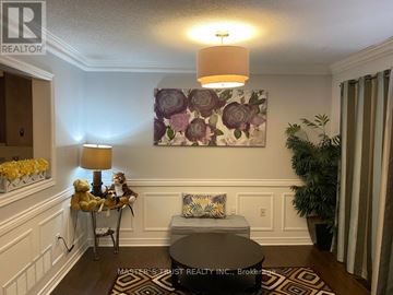 Mississauga (East Credit) townhouse for rent - A living room with a couch, a table, a lamp, and a painting on the wall.